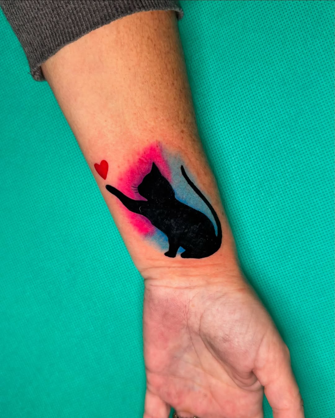 Tatuaż kota z sercem na przedramieniu — akwarelowy, Talar ink tattoo, Kraków